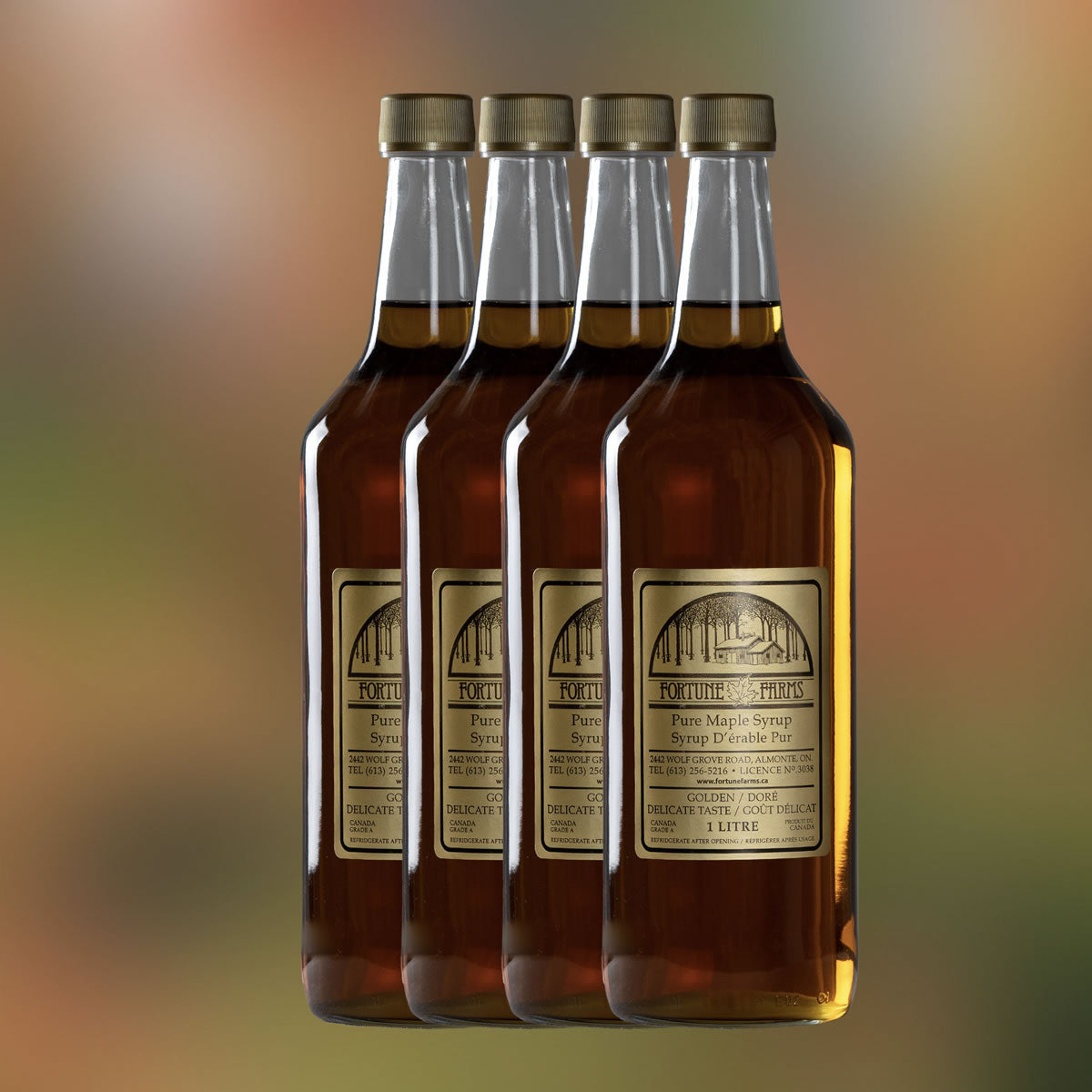 A photo of 4 glass bottles of maple syrup