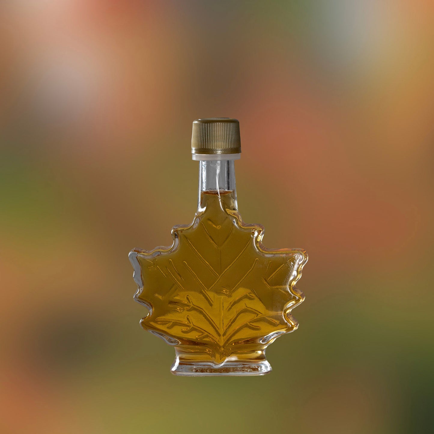 Photo of 50ml mini bottle of maple syrup with a maple leaf shape.