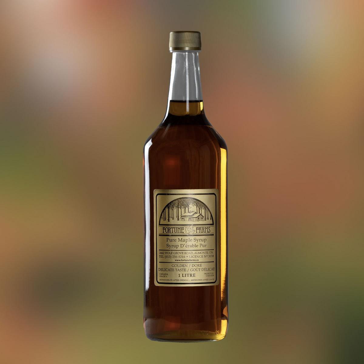 Photo of a single glass bottle of maple syrup